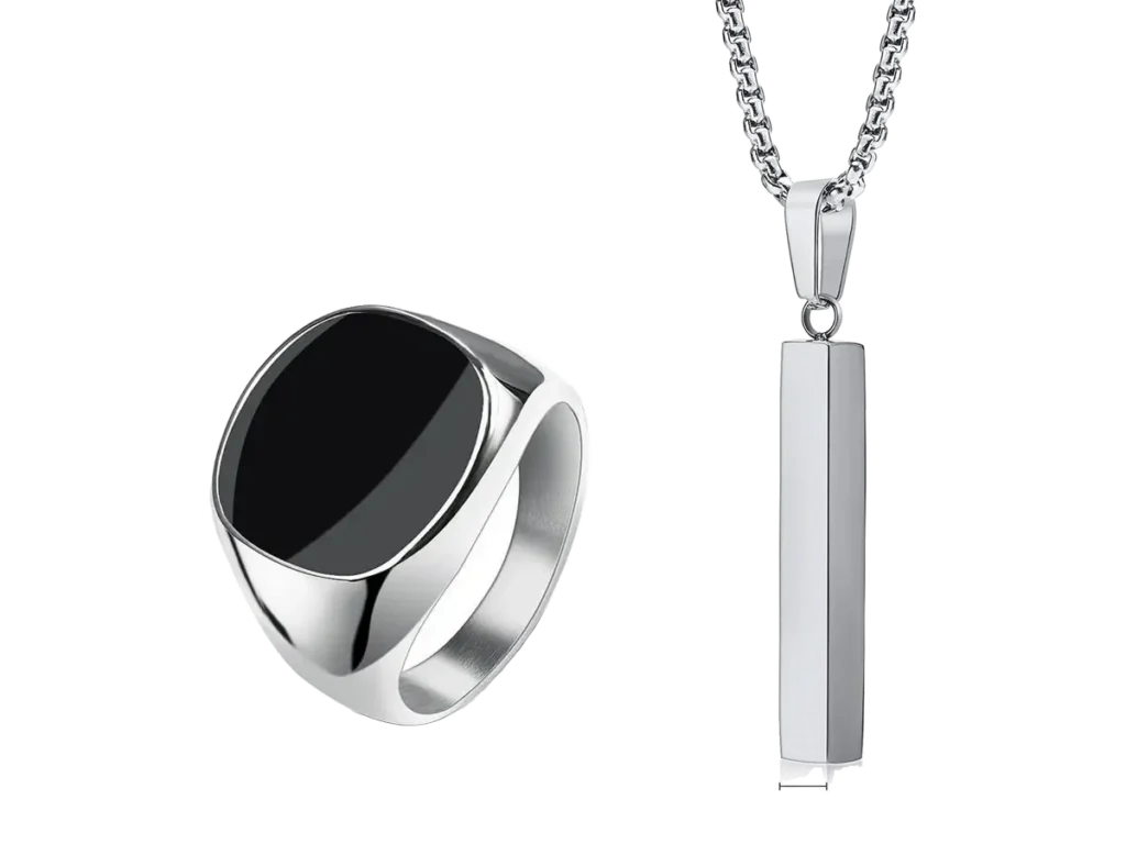 A black top signet ring beside a vertical bar pendant, in stainless steel