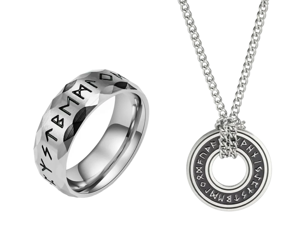 Faceted rune ring beside a round rune pendant, in stainless steel